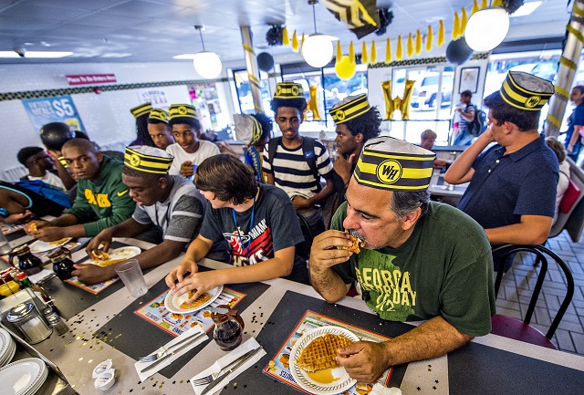 Steve Schultz, Jacob Poe, Jonah Wildgoose and Jason McLin compete in the championship round of the waffle eating contest at the Waffle House in Decatur on Friday. Photo: Jonathan Phillips