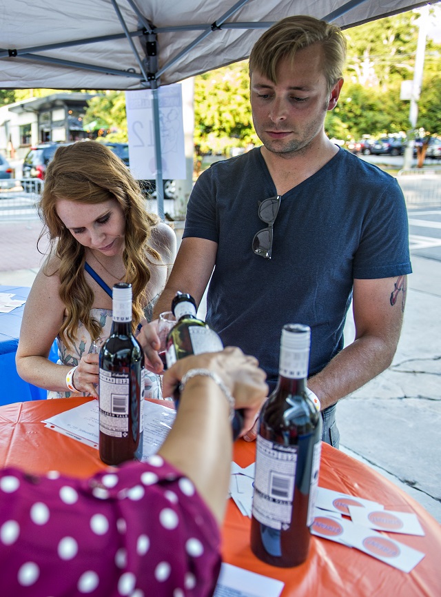 Brooke Brown (left) and her husband Lauren have their glasses filled with wine during the Kirkwood Wine Stroll on Friday. Photo: Jonathan Phillips