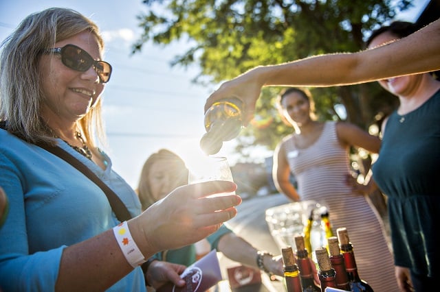 Heather Borowski holds her glass as wine is poured during the Kirkwood Wine Stroll on Friday. Photo: Jonathan Phillips