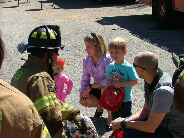 A DeKalb fireman talks to a family about fire safety. Photo provided by DeKalb County Fire Rescue