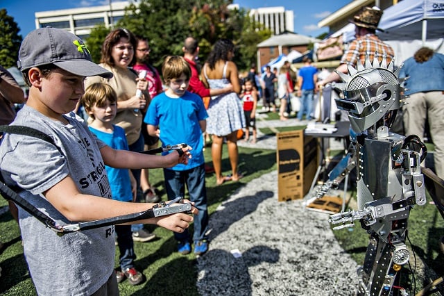 Alex Robinson controls a robot using his arms during the Atlanta Maker Faire in Decatur on Saturday. Photo: Jonathan Phillips