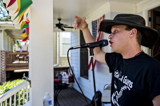 Collin Killtrick performs off of Olympic Pl. during the annual Oakhurst Porchfest on Saturday. Photo: Jonathan Phillips