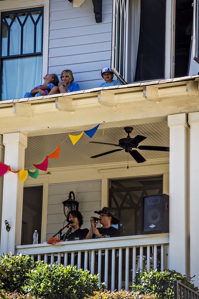 Children sit on the roof above Daniel Hearn and Collin Killtrick as they perform during the annual Oakhurst Porchfest on Saturday. Photo: Jonathan Phillips