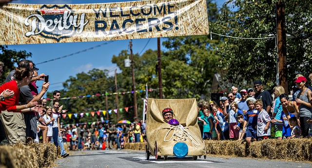 With her father riding copilot, Leah Silver takes her roller skate down the street during the 6th annual Madison Ave. Soapbox Derby in Oakhurst on Saturday. Photo: Jonathan Phillips