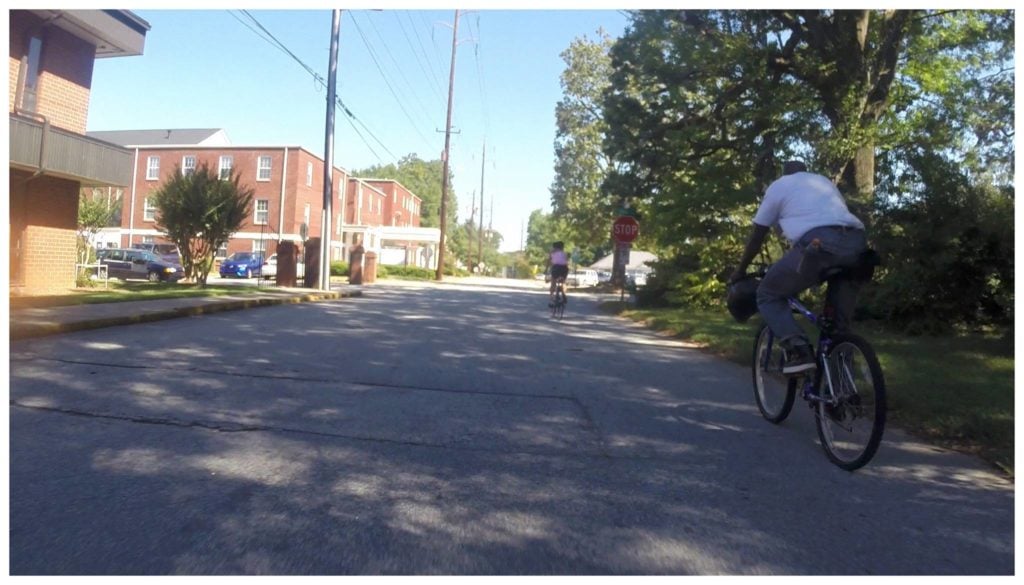Photo of Robert McKenzie following a female cyclist. Photo provided by Clay Walker
