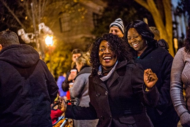 Astrud Ferguson (center) dances to music as she waits for Santa to arrive during the annual lighting of the tree in Decatur on Thursday. Photo: Jonathan Phillips