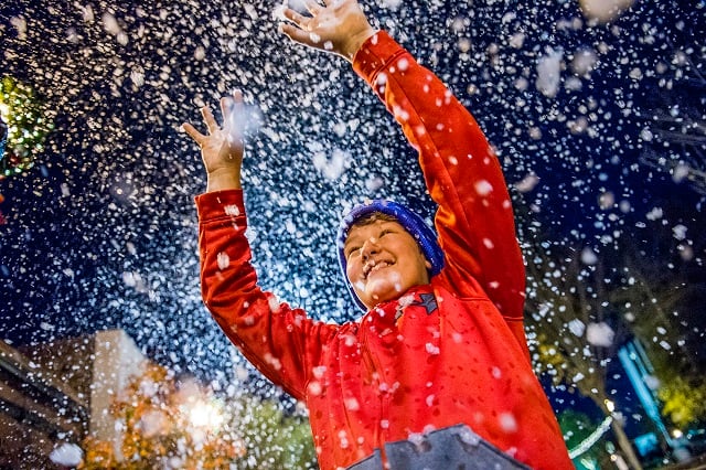 Chandler Jones plays in the "snow" during the annual lighting of the tree in Decatur on Thursday. Photo: Jonathan Phillips