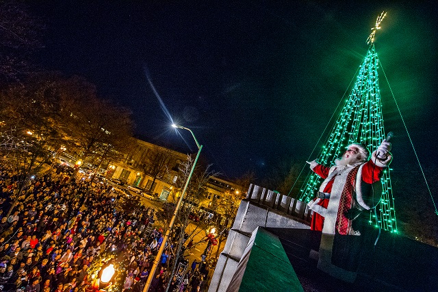 Santa Claus makes his exit after lighting the tree on top of Little Shop of Stories during the annual lighting of the tree in Decatur on Thursday. Photo: Jonathan Phillips