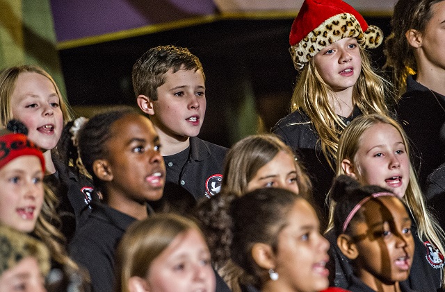 Katie Jane Thompson (top right) sings Christmas carols with the Voices of Fifth Avenue choir during the annual lighting of the tree in Decatur on Thursday. Photo: Jonathan Phillips